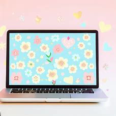 Create a beautiful image of a laptop computer with a cute and colorful wallpaper displaying patterns of flowers, hearts and stars.