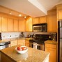 Image result for Giallo Ornamental Granite with Grey Cabinets