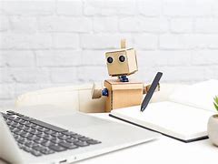 Image result for Robot Sitting at a Desk On a Laptop
