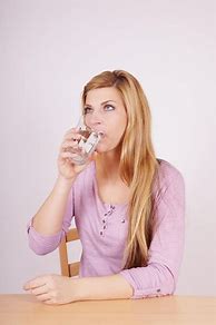 Image result for Picture of Someone Drinking Water at Dinner Time