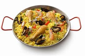 Image result for Paella Being Cooked in a Paellera