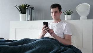 Image result for Person On Phone in Bed