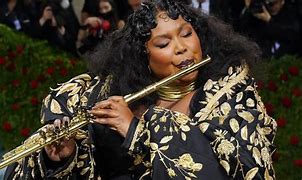 Image result for Lizzo Black Dress and Flute