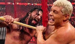 Image result for Cody Rhodes vs Seth Rollins HIAC Torn Kendo Stick On Torn PEC