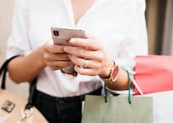 Image result for Image of a Girl Buying Phone In-Store