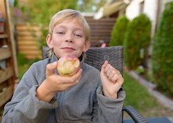 Image result for Boy Eating Apple Under Tree