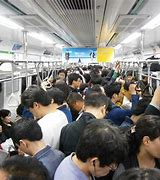 Image result for People in Tokyo Fighting to Get On the Train