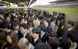 Image result for People in Tokyo Fighting to Get On the Train
