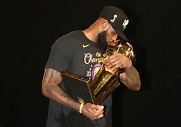 Image result for LeBron Holding Up 4 NBA Trophy