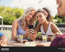 Image result for Two People Looking at Phone