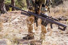 snipe bid soldier with big sniper rifle in forest stock photo snipe bid soldier with big sniper rifle in forest stock photo