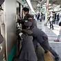 Image result for People in Tokyo Fighting to Get On the Train