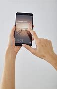 Image result for hands holding huawei phones