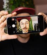 Image result for Person with iPhone SE 3