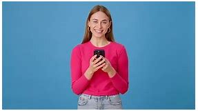 Young Lady Using Mobile Device for Texting and Smiling