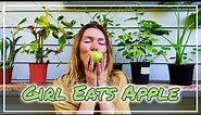 girl eats green apple