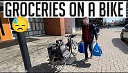 Using a bicycle to carry a week's worth of groceries in four different ways