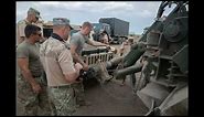 U.S. Soldiers and Romanian Land Forces soldiers train together on the M1089 Wrecker