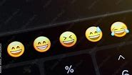 Selects the mock emoji from a range of other emoji on the laptop and sends the emote
