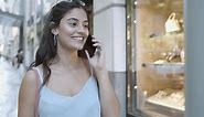 Free stock video - Cheerful pretty young woman talking on mobile phone and smiling