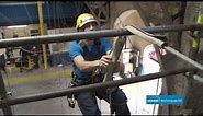 Industrial abseiling over an edge in rope access. Access Techniques Ltd