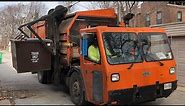 2 Orange Commercial Side Loader Garbage Trucks in St Louis Alleys