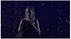 Silhouette of a Woman Performing an Element of Bachata Dance of the Among the Raindrops. Black