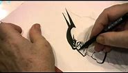 Neal Adams Drawing Batman inside a copy of the Art of Neal Adams