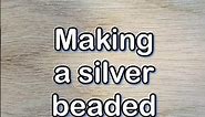 Making a silver bead chain.