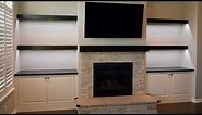 Custom built in cabinets, floating shelves and fireplace mantel