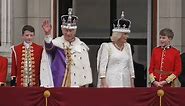 King and Queen wave from Palace balcony to onlooking soggy crowds