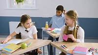 Free stock video - Two female students sitting at desk in english classroom