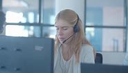 Free stock video - Serious young female operator in headset talking to customer