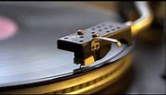 The vinyl record on DJ turntable record player close up. The rotating plate and stylus with the