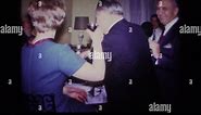 ROCKAWAY BEACH NEW YORK USA-1967: 1960s Well Dressed People Passing Drinks At A Stock Video Footage - Alamy