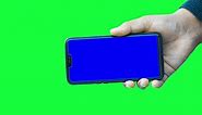 Premium stock video - Hand of a man holds a modern smartphone mockup against the green screen chroma key