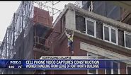 Man hangs off side of a building after scaffolding elevator collapses, 3 injured