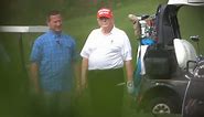 Trump wears his signature MAGA hat while golfing in Florida