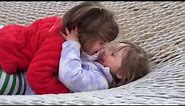 Baby identical twin sisters in the hammock at 2 ½ years old. Lots of cute giggles & kisses.