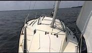 San Juan 24 sailboat sails itself in steady breeze