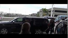 Denim Demi! Demi Lovato arrives at LAX in sleeveless jean jumper