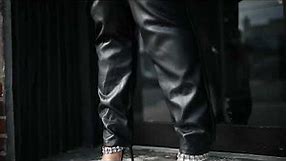 Black leather Jumpsuit bodysuit for women. Girl in black leather Jumpsuit overalls.
