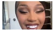 Cardi B smiles bright and proudly shows off her missing tooth