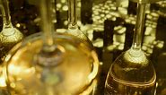 Ethereal golden reflections of a set of champagne glasses - Free Stock Video