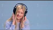 Charming girl with headphones listening to music