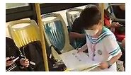 XuQinduo - A primary school student doing his homework on...