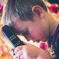 Boy Holding Holy Bible Book