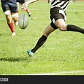 Kicking a Rugby Ball to Person From Hand