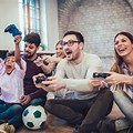 People Playing On Games Console
