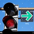Red Traffic Light with Green Arrow Sign Image